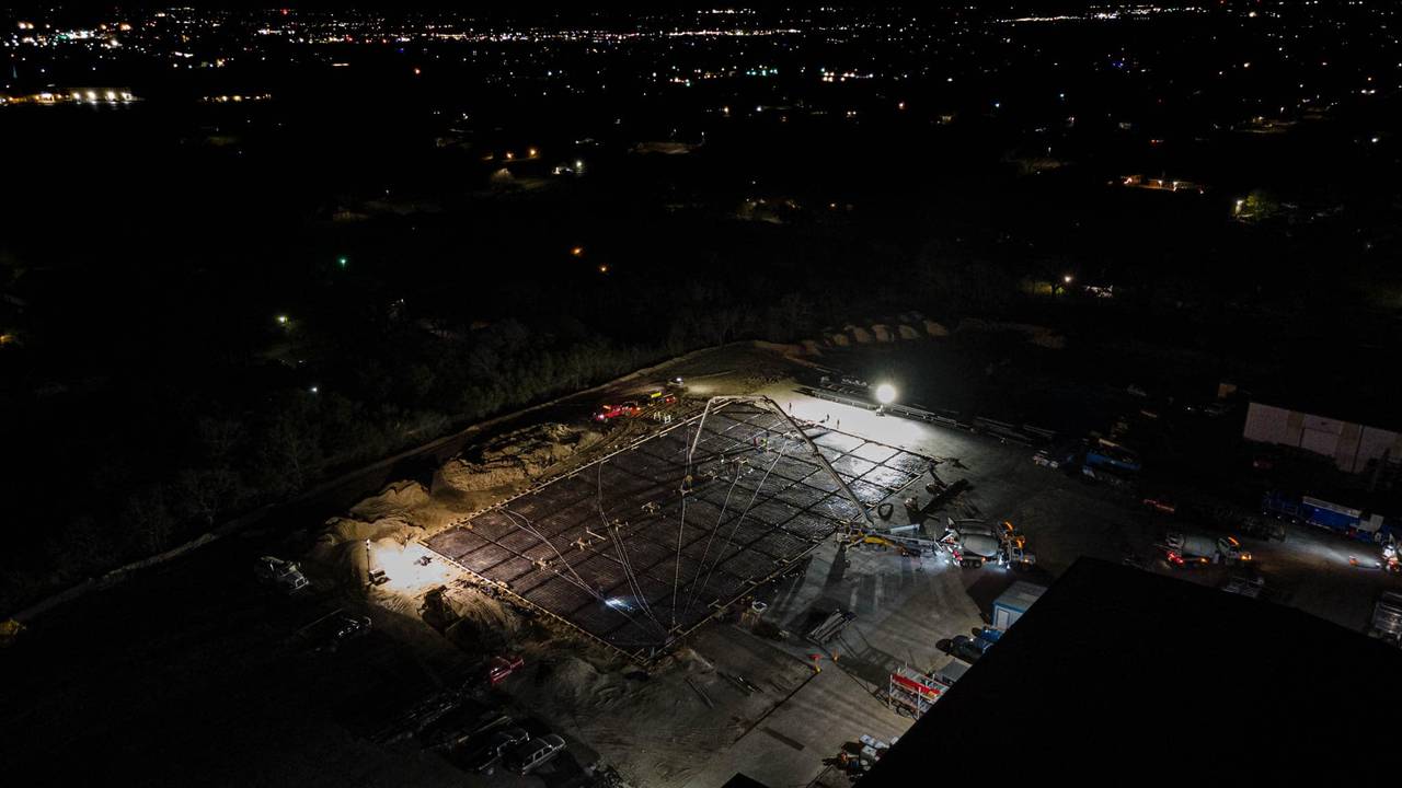 Brazos Metal crew and equipment working a foundation pour on a Texas job site at night